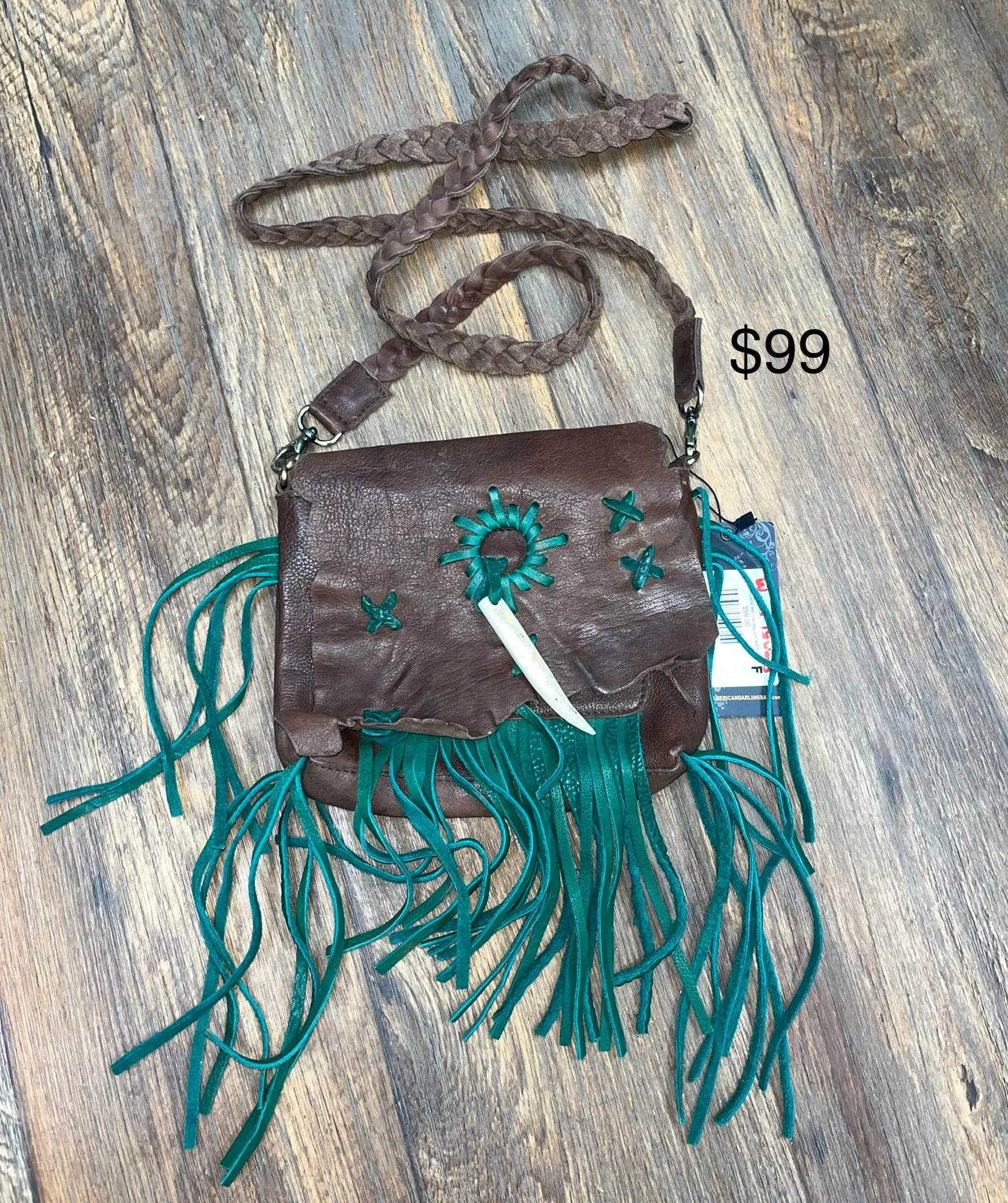 Chocolate leather fold over bag with teal fringe